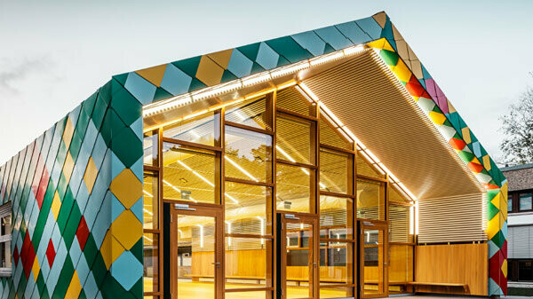 Mensa moderna per due scuole a Stoccarda rivestita di Scaglia PREFA per copertura e facciata in colori speciali. 