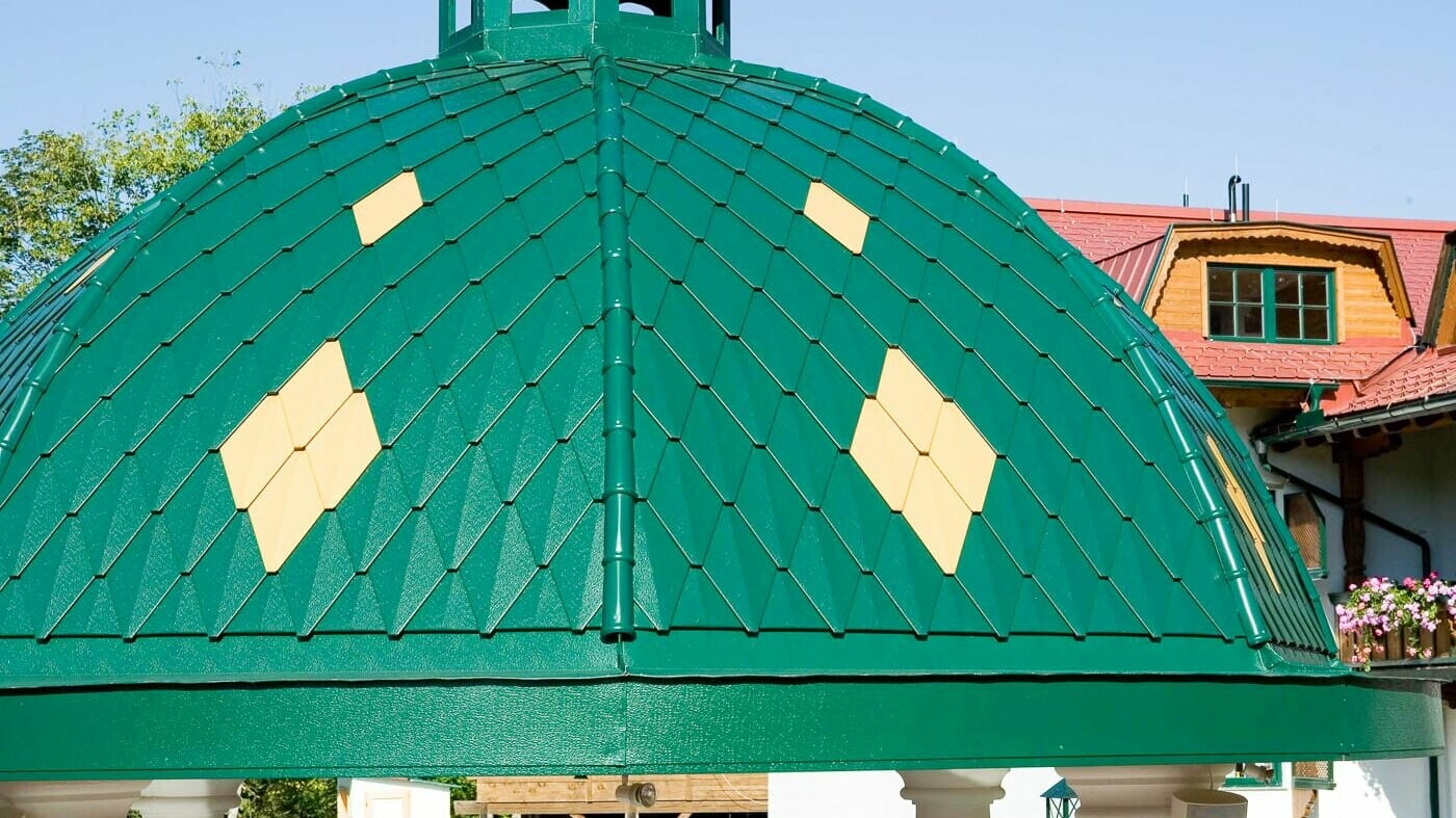 cupola tonda rivestita con le scaglie piccole PREFA nel colore verde muschio.