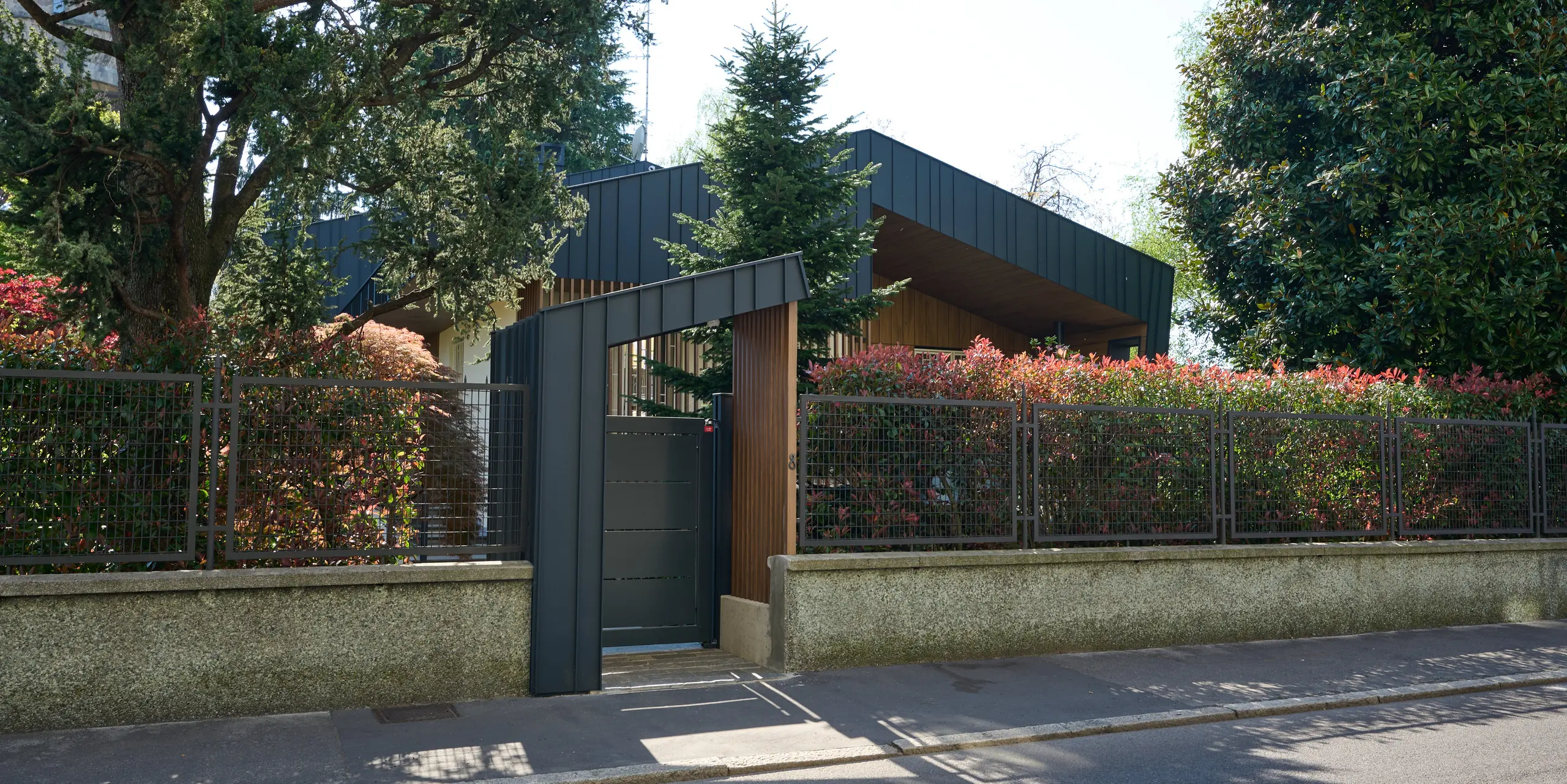 Die Straßenansicht der Villa Castellanza beeindruckt mit ihrer markanten Architektur, die durch das PREFALZ Dach und die Fassade in der Farbe P.10 Anthrazit entsteht. Klare Linien, elegante Aluminiumoberflächen und die harmonische Einbindung in die grüne Umgebung machen das Gebäude zu einem echten Blickfang. Die langlebigen PREFA Systeme aus Aluminium vereinen modernes Design, Nachhaltigkeit, Witterungsbeständigkeit und einen geringen Wartungsaufwand auf höchstem Niveau.