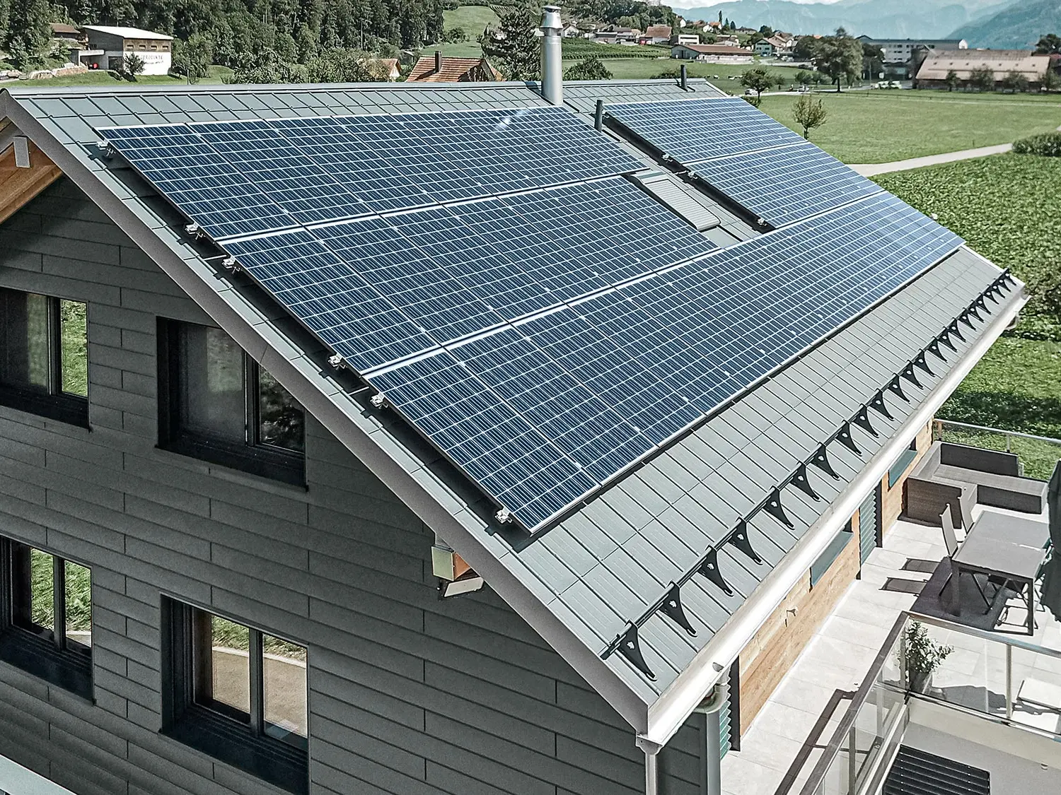[Translate to Deutsch:] Photovoltaikanlage auf PREFA Dach montiert mit den Solarhaltern und der Profilschiene für sicheren Halt.