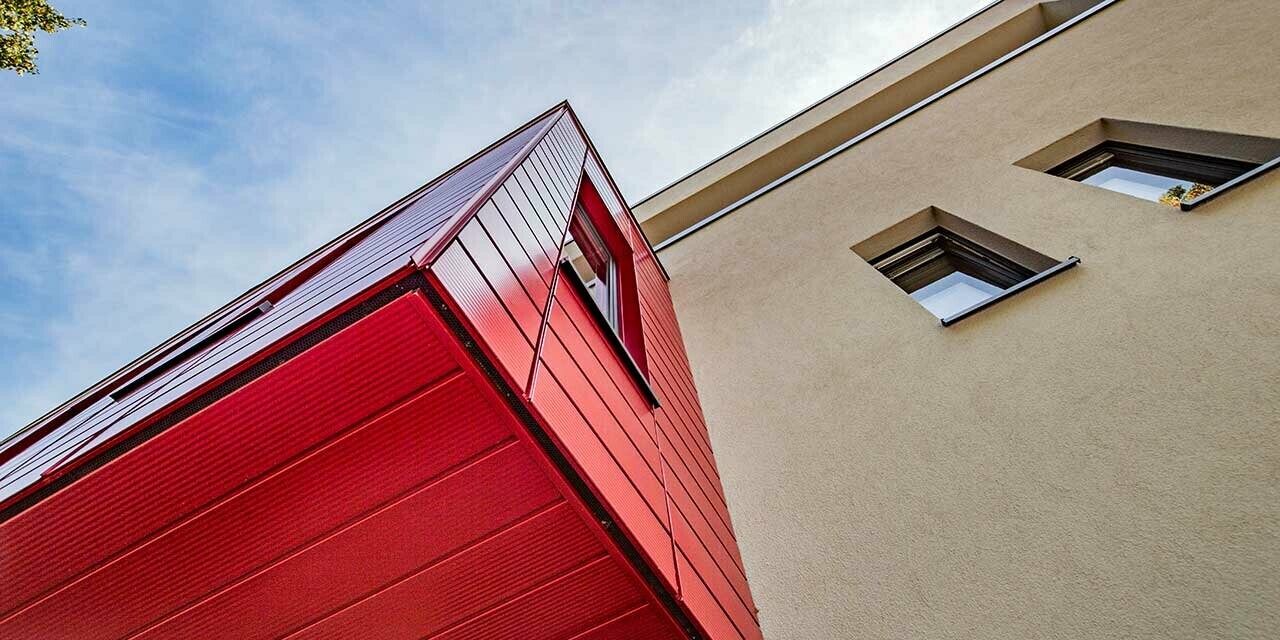 Bovindo con doghe PREFA rigate in rosso rubino in una moderna casa unifamiliare a Wernigerode, qui è fotografato l’intradosso del fabbricato aggiunto aggettante.