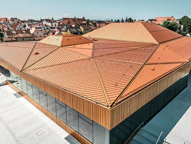 Centro congressi Lindau rivestito con PREFA Falzonal in marrone rosso.