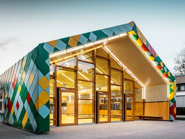 Mensa moderna per due scuole a Stoccarda rivestita di Scaglia PREFA per copertura e facciata in colori speciali. 